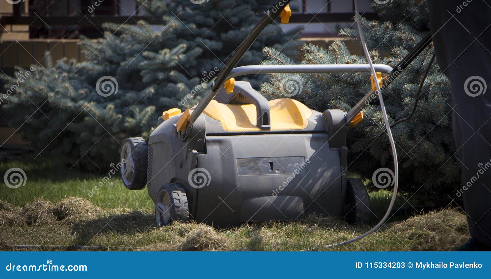 Gardener Operating Soil Aeration Machine on Grass Lawn Stock Image