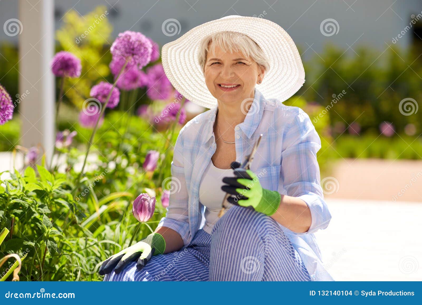 senior woman with garden pruner and flowers