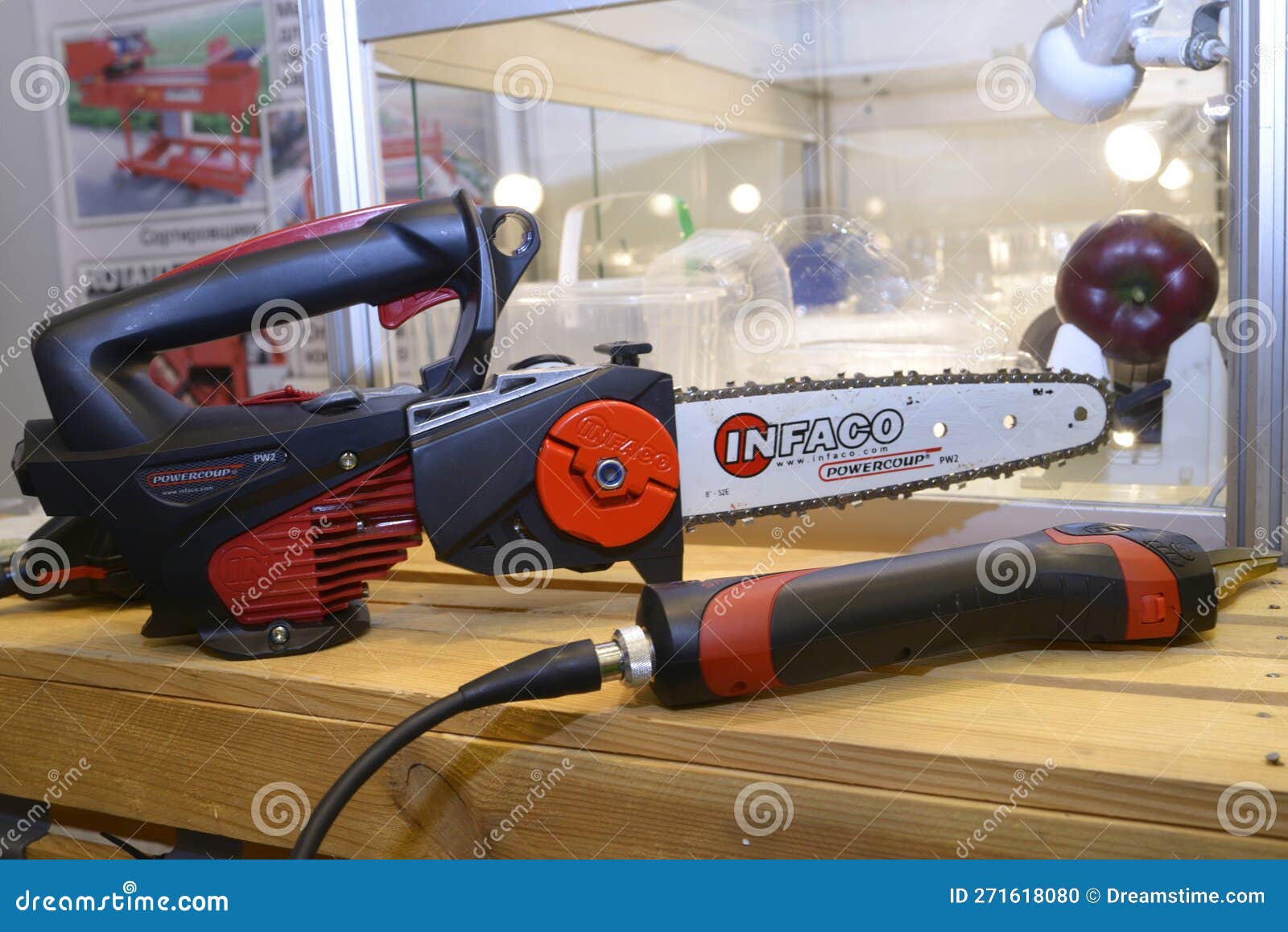 Gardening Tools Electrical Chainsaw and Secateurs Placed on a Stand