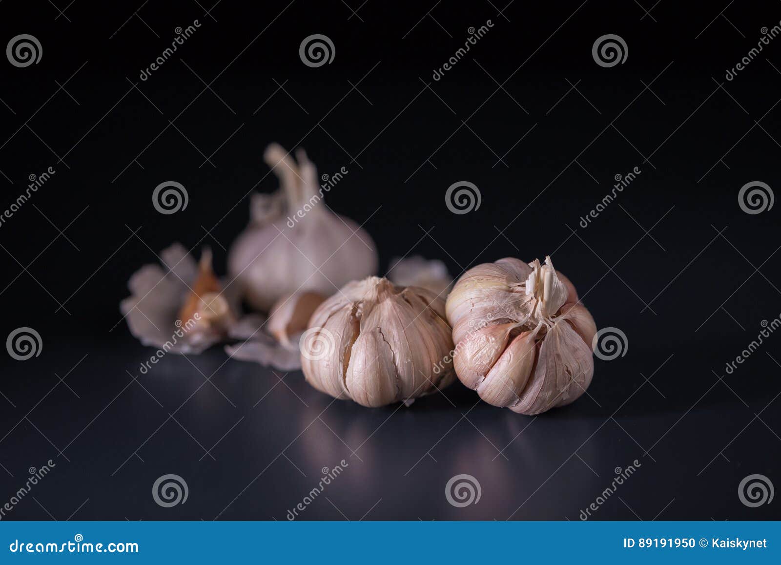 Garlic. Fresh Garlic. Cloves of Garlic on Black Background. Stock Photo