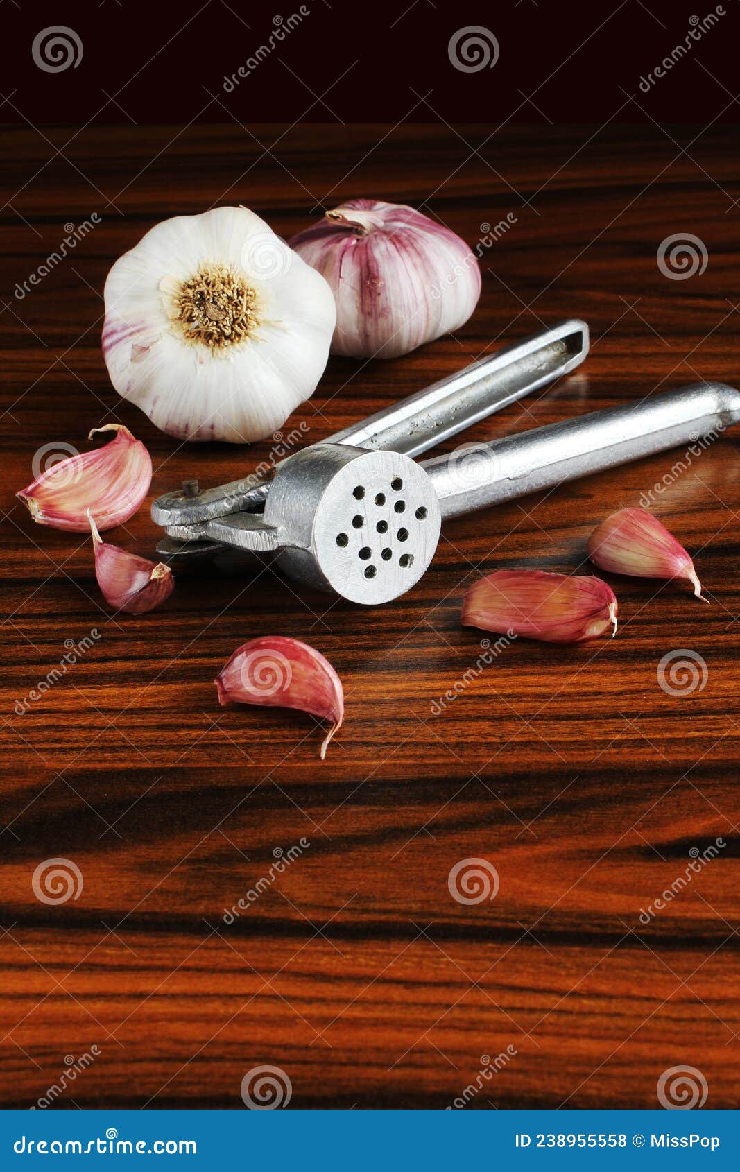 Garlic Press. Garlic Bulbs and Garlic Cloves on the Wooden Table Stock