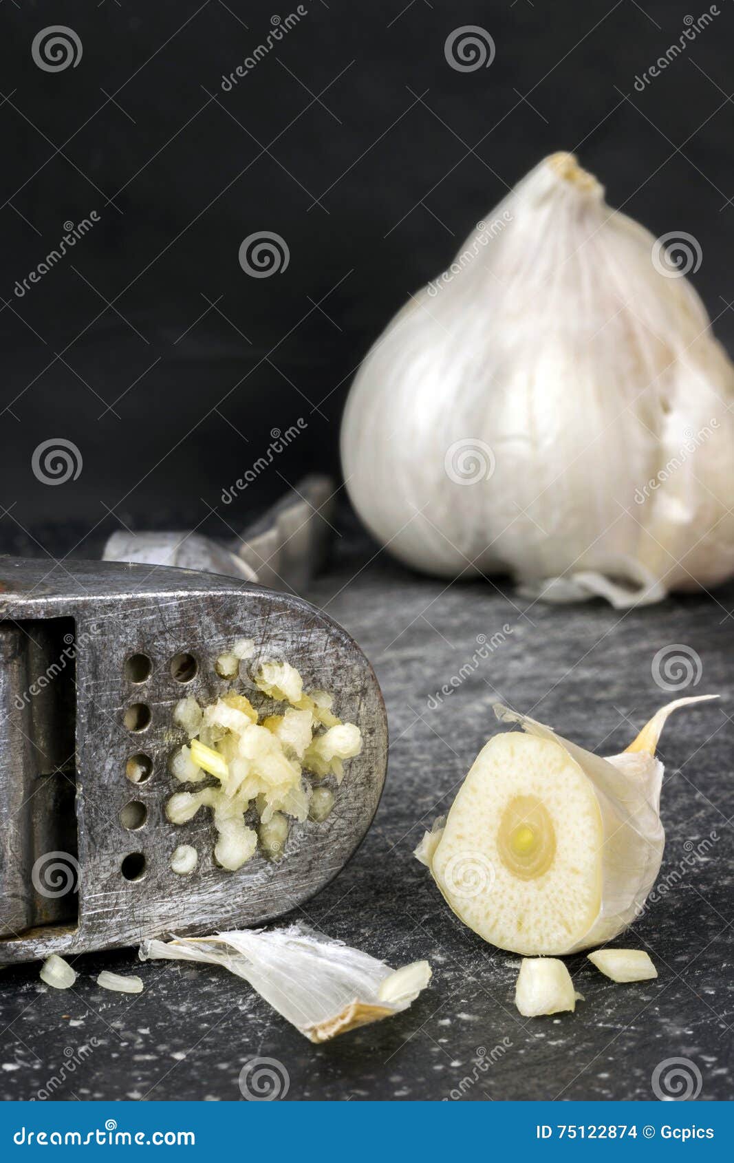 Garlic Press with Cut Garlic Clove Stock Photo Image of close, board