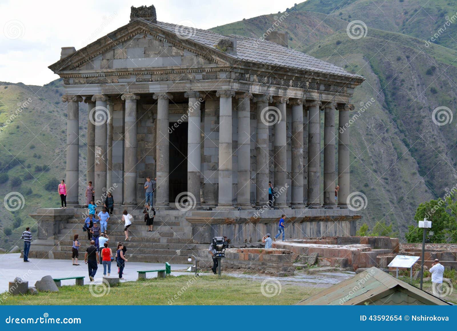 Garni temple in summer. Garni temple with the tourists walking nearby in the summer day