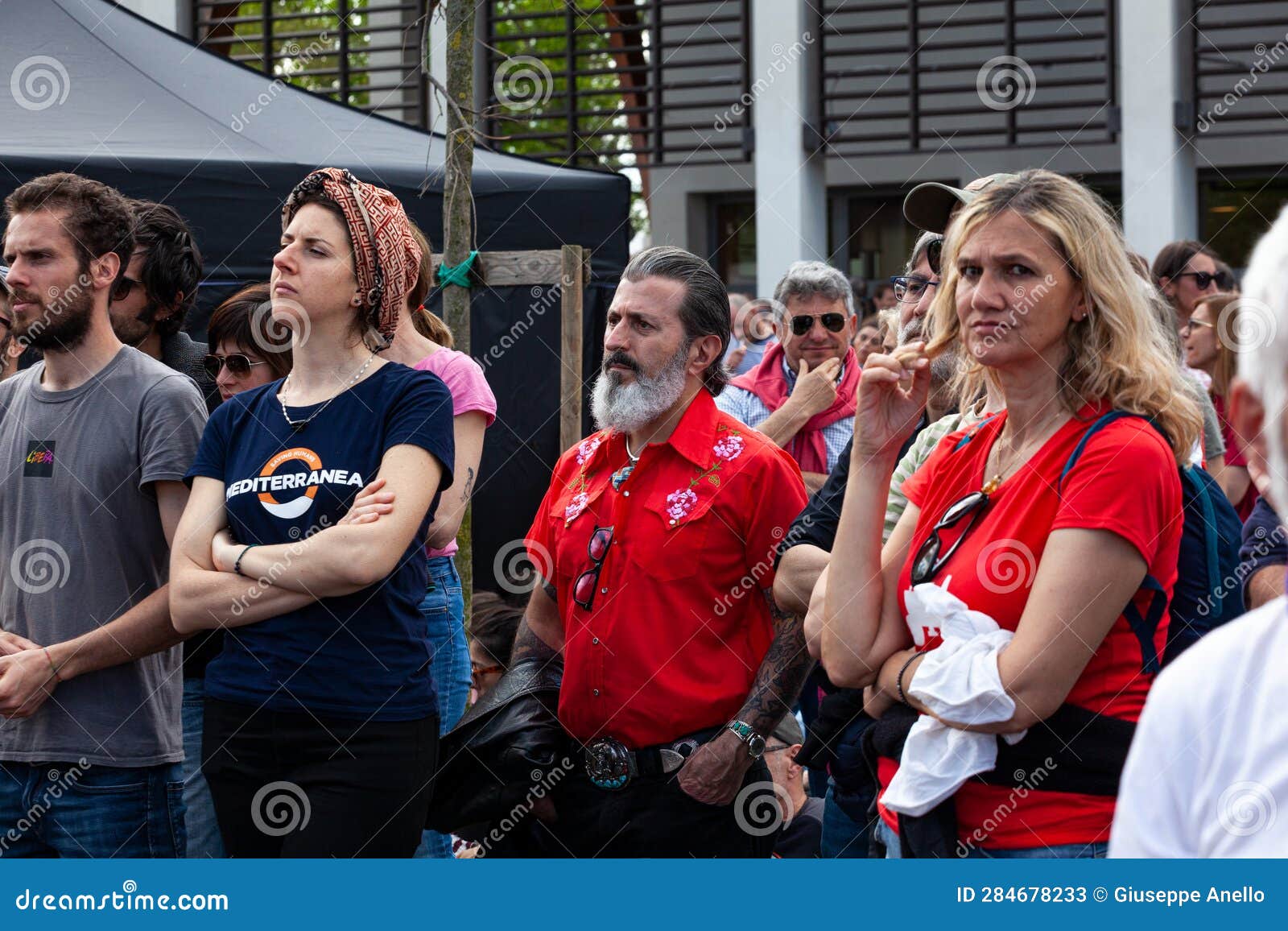 A Gathering of Left-wing Supporters Wearing Red Shirts Attentively ...