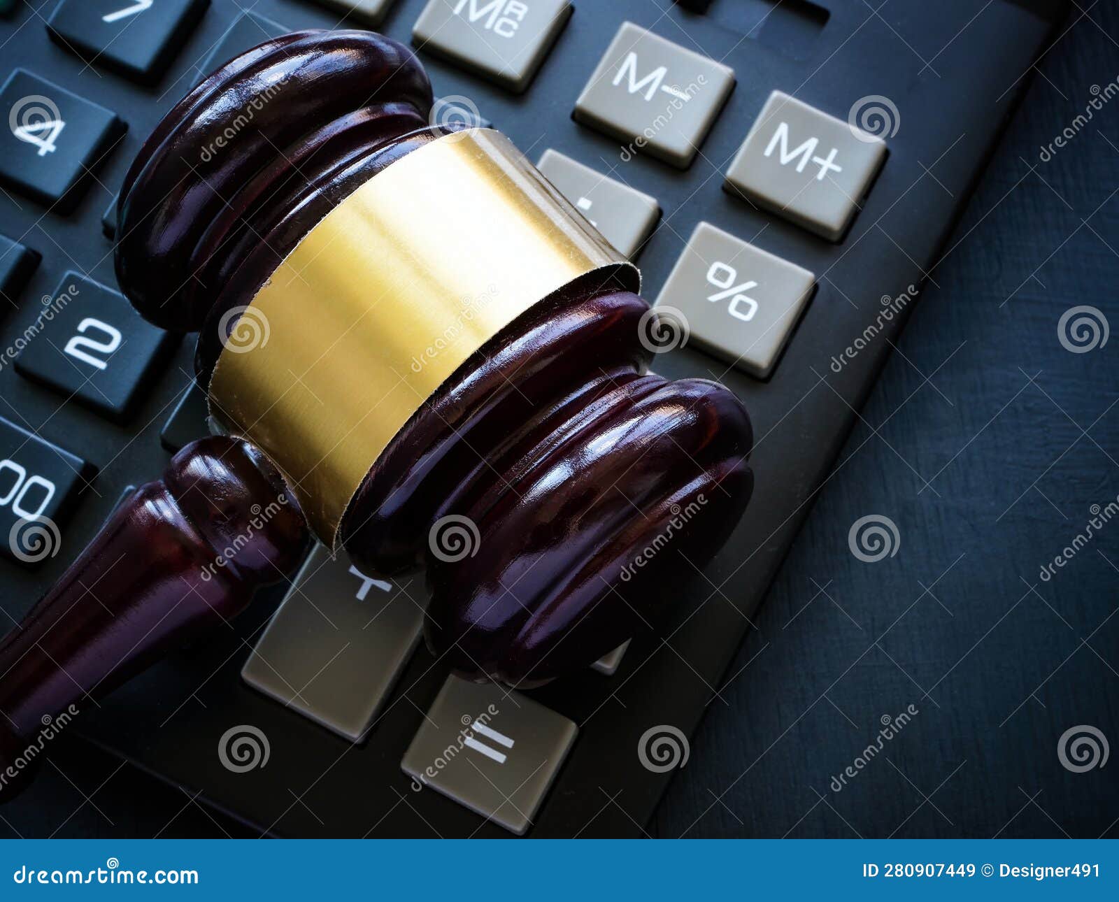 the gavel lies on the calculator as a concept of economic crimes and tax evasion.