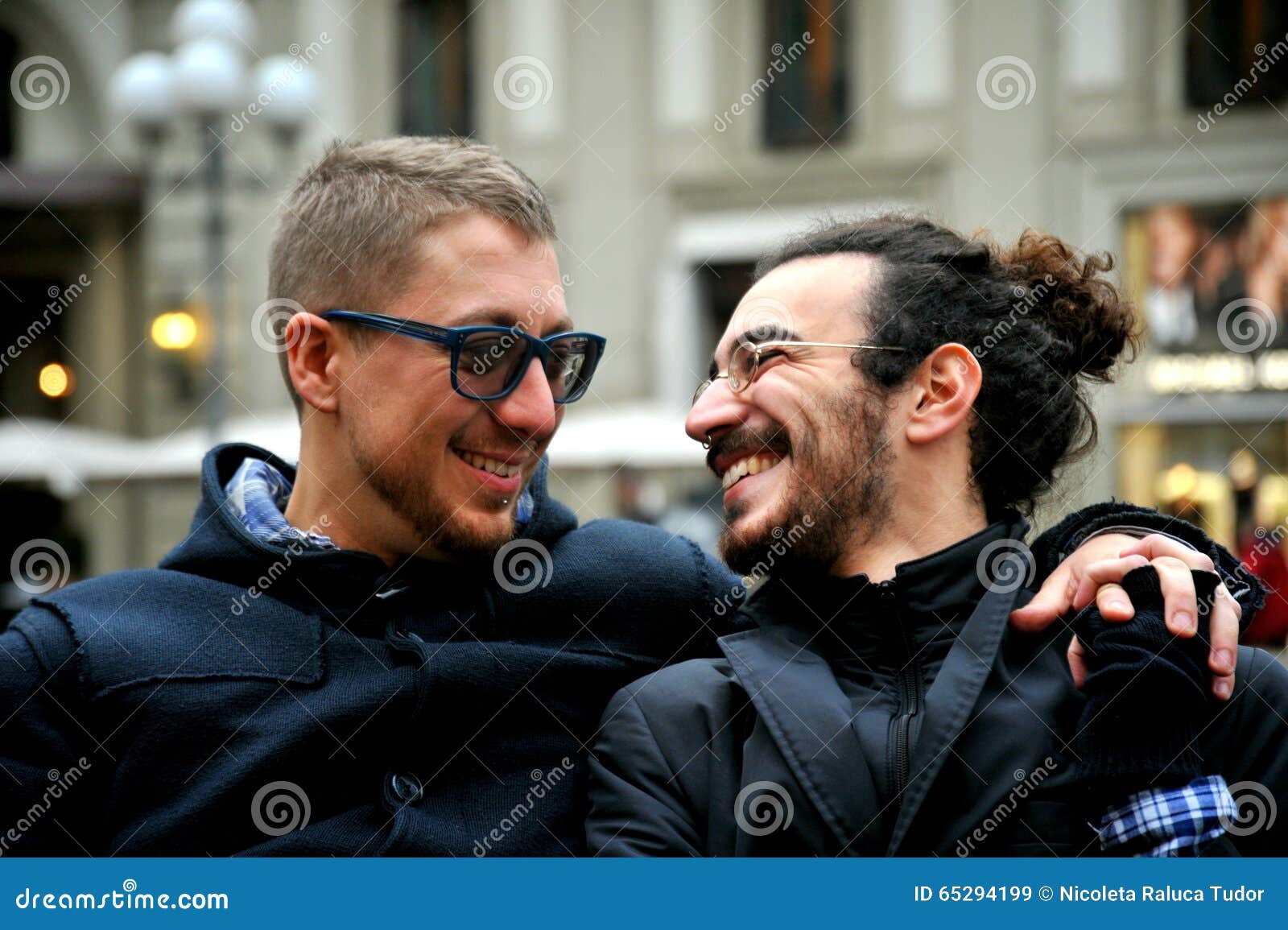 gay couple smiling on the streets of florence , italy