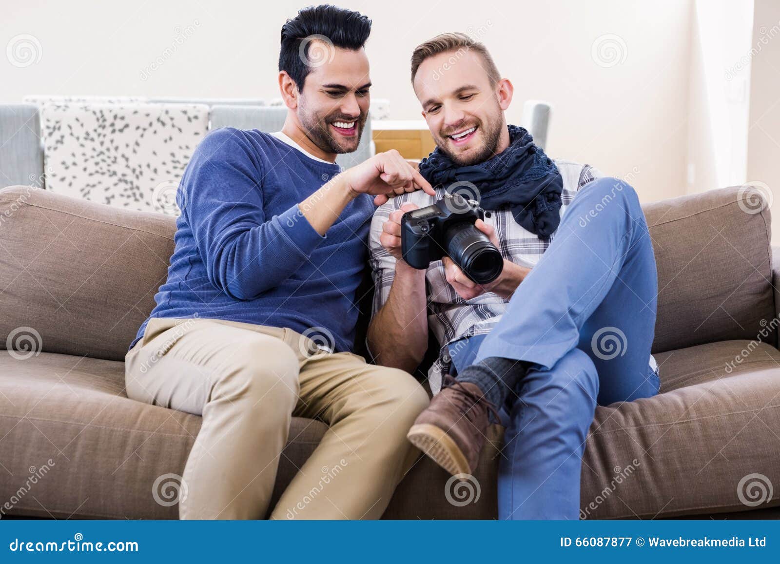 Gay Couple Watching Pictures On The Couch Stock Image Image Of People Homosexual 66087877