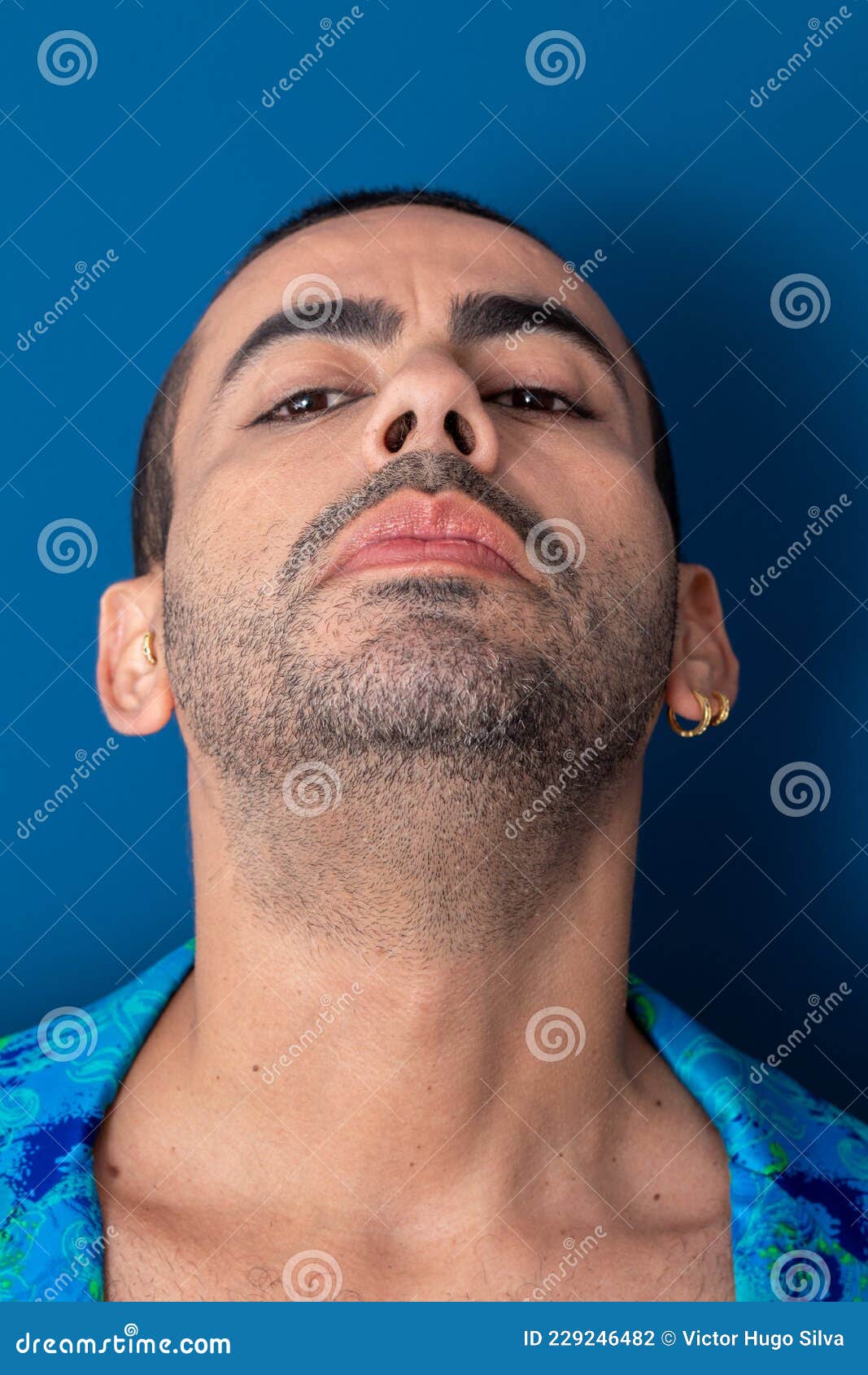 gay man with colorful nails, rainbow colors, freedom, no prejudice, beautiful nails, blue and green clothes on a blue background.