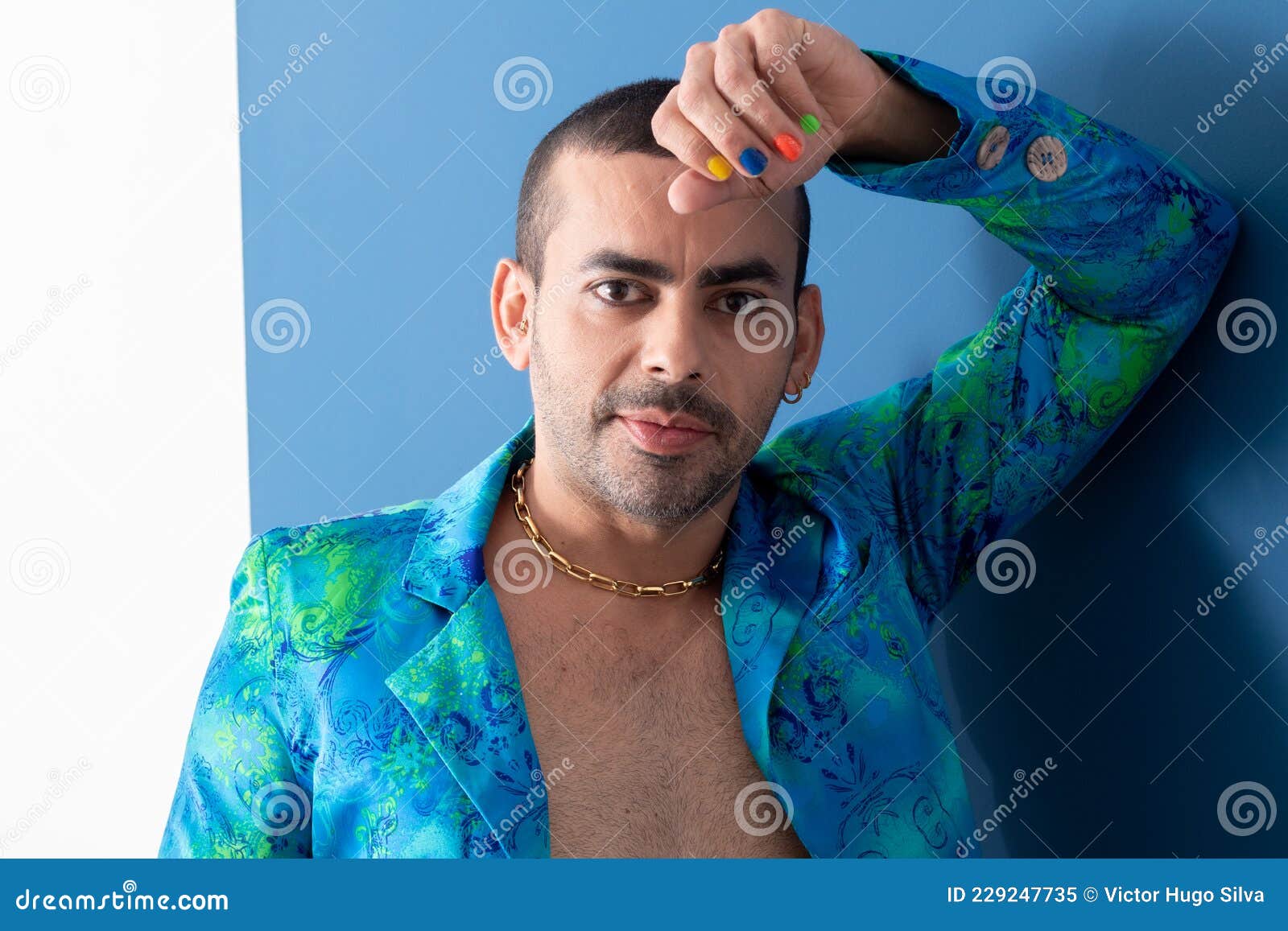 gay man with colorful nails, rainbow colors, freedom, no prejudice, beautiful nails, blue and green clothes on a blue background