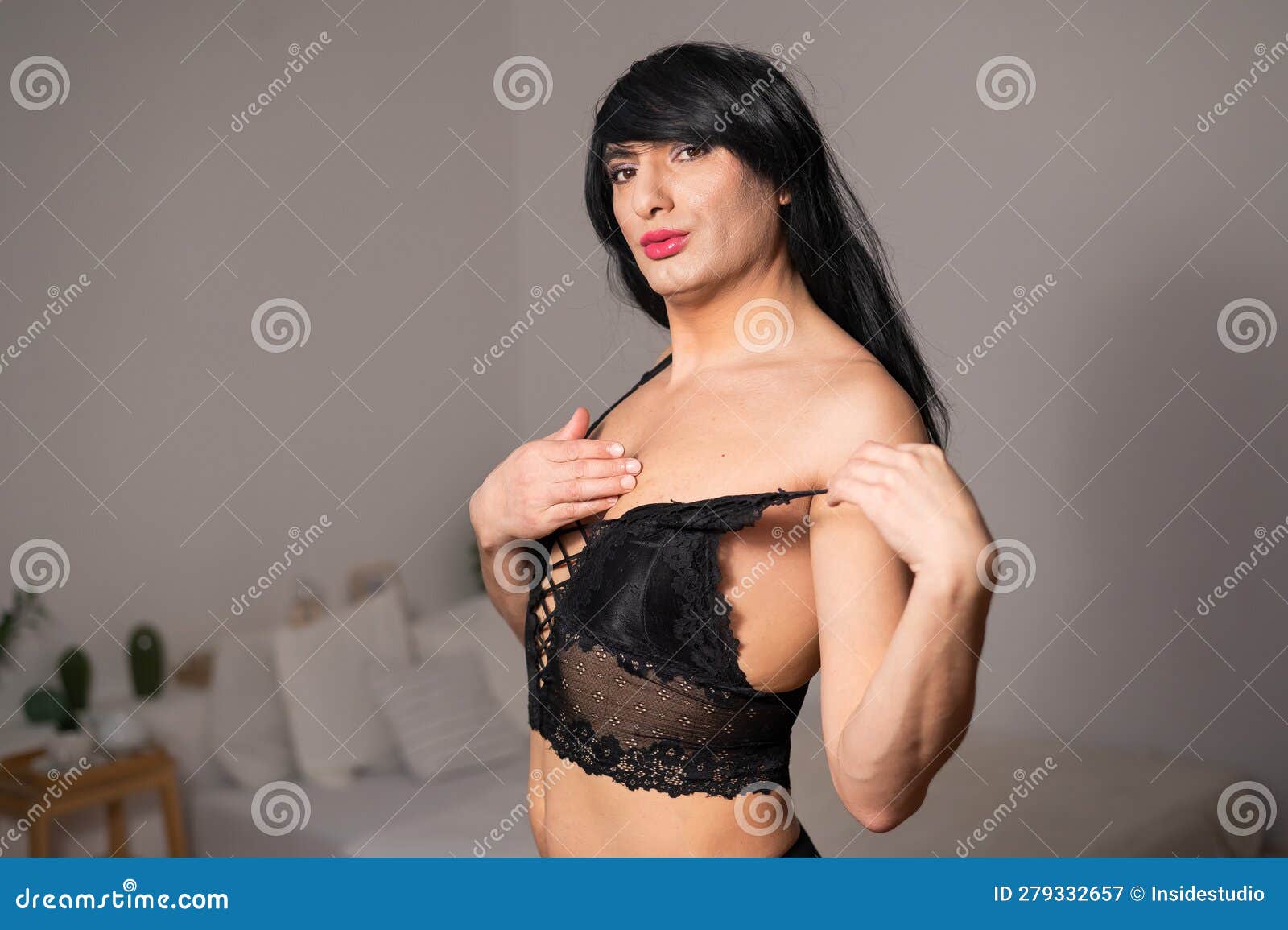 Young man in a red women's bra. Gay Stock Photo