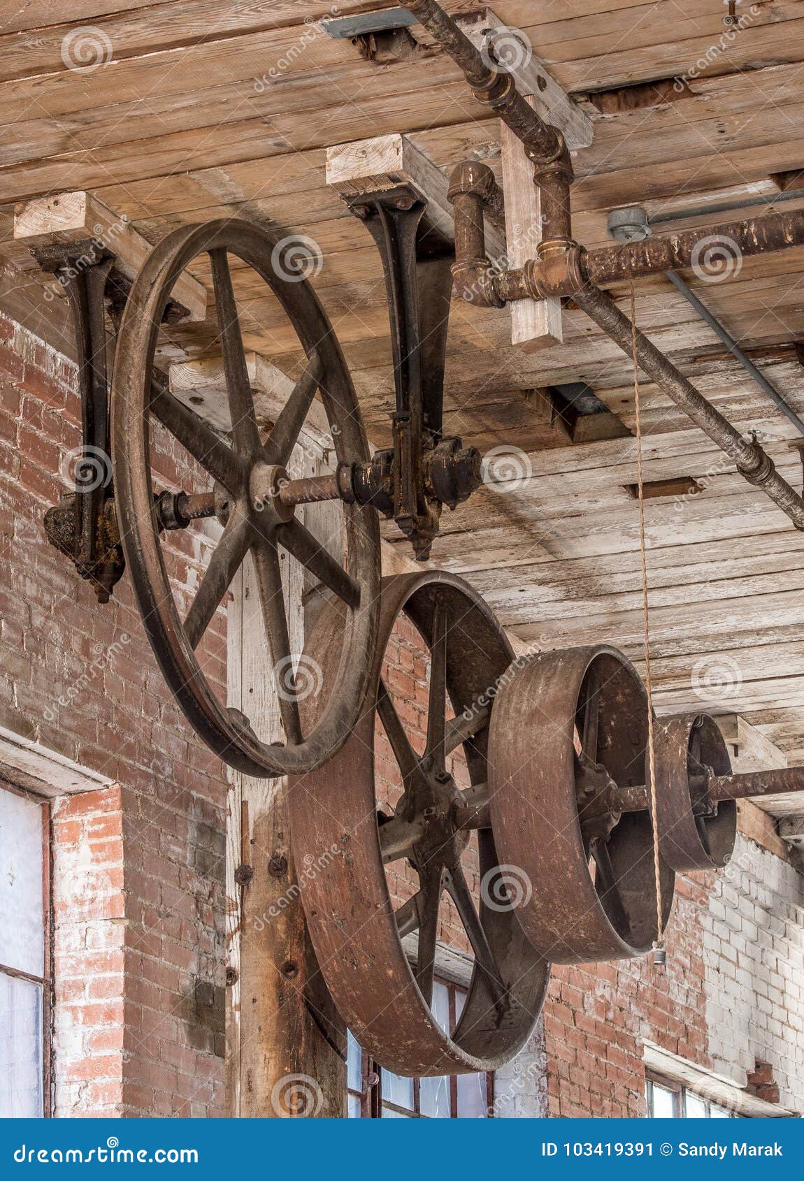 Gears And Pulleys On A Ceiling In Old Warehouse Stock Image