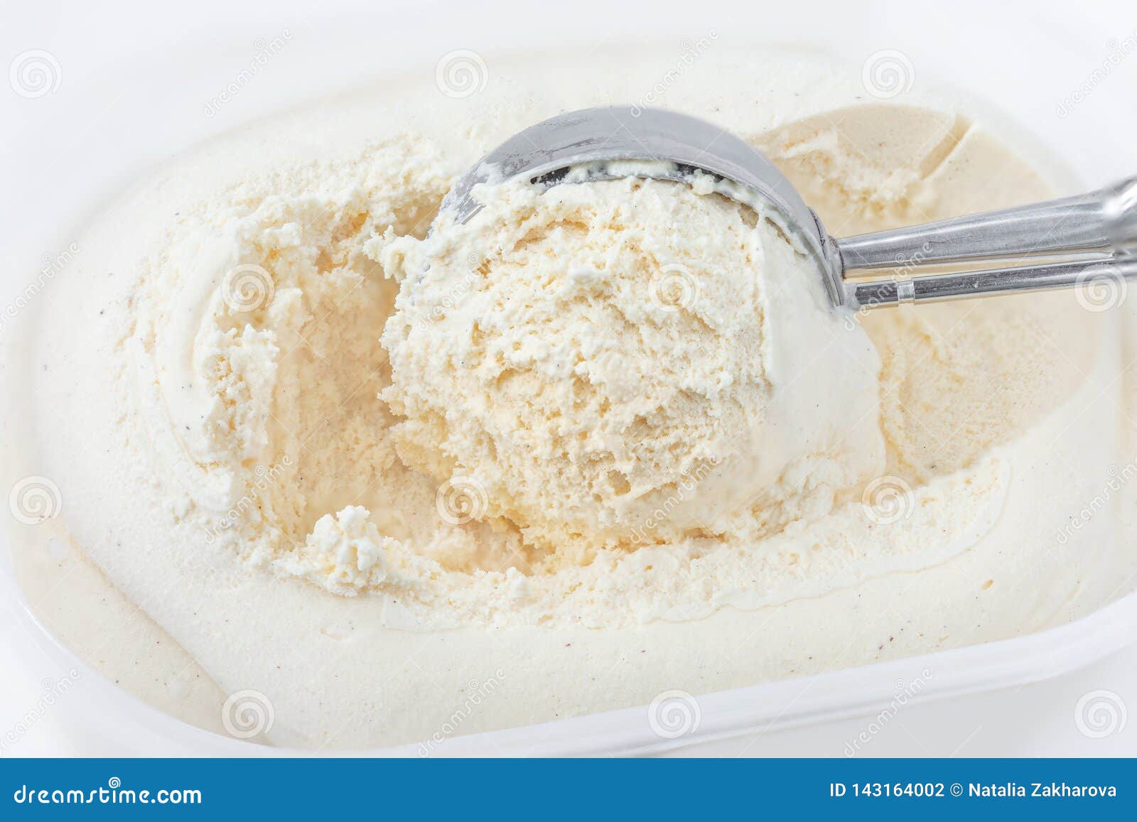 Gelato alla vaniglia con un mestolo in contenitore come fondo Macro Gelato fuori scavato, vista superiore