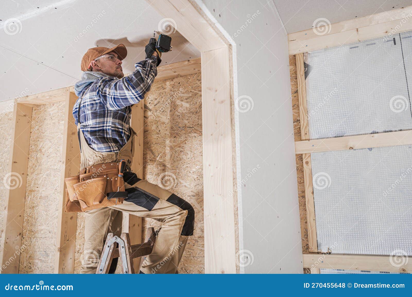 General Construction Contractor Worker Attaching Drywall Using Drill