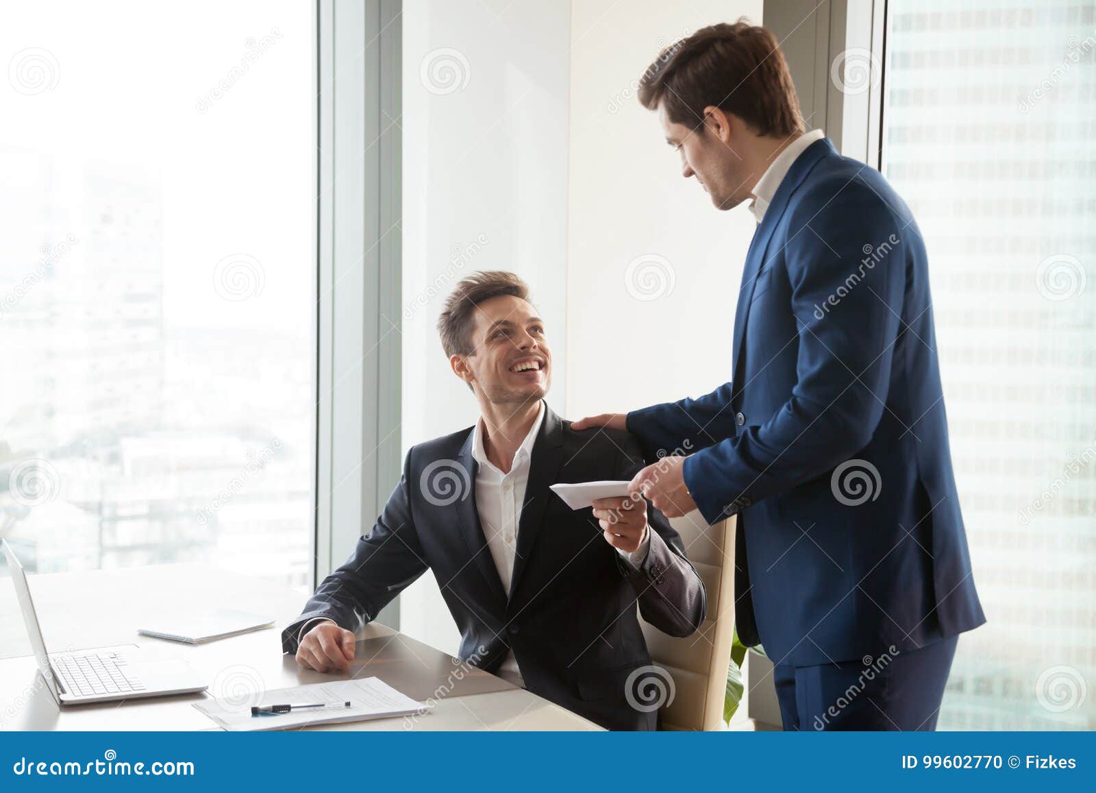 boss giving money premium to happy employee