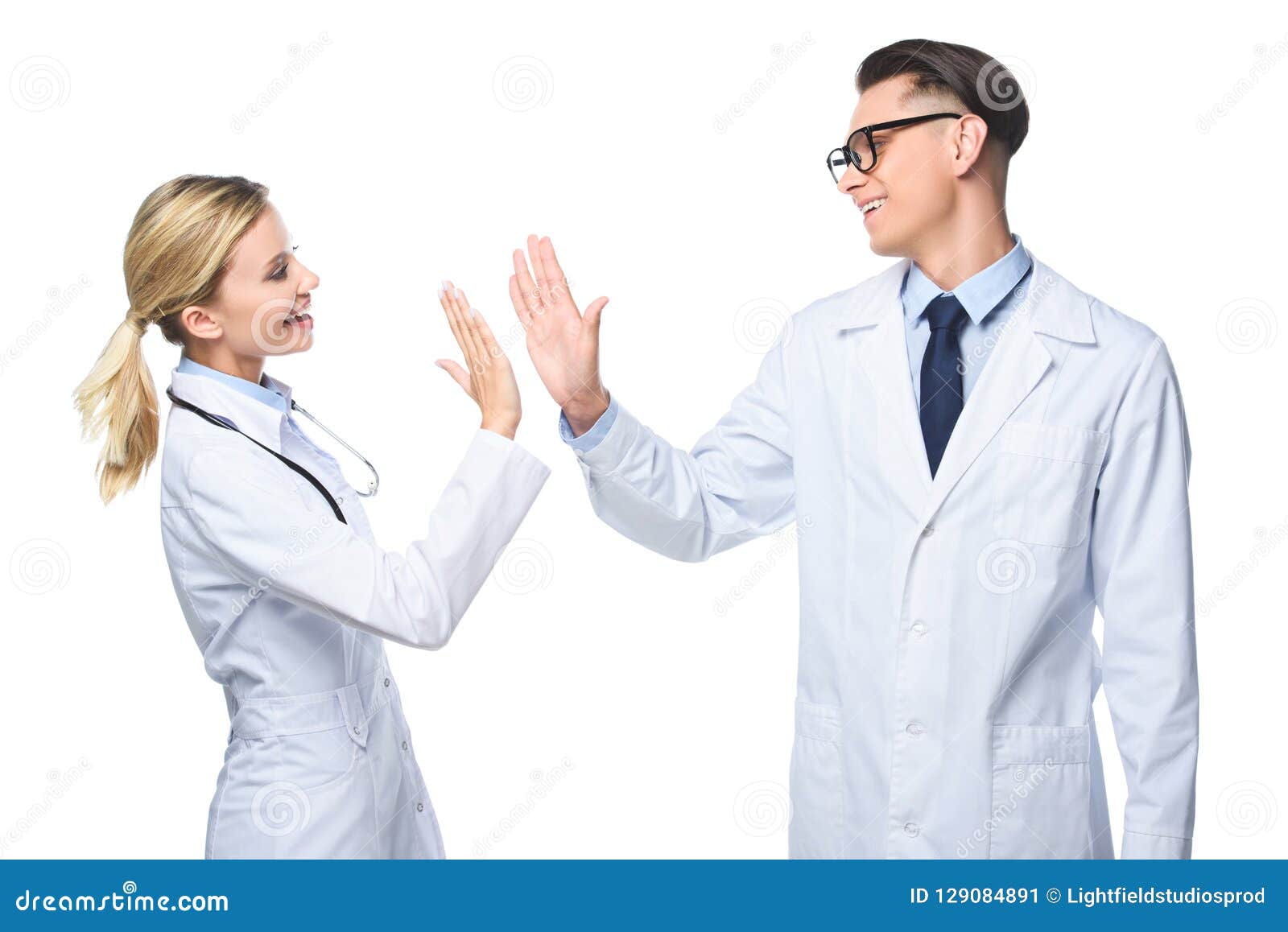 General Practitioners in White Coats Giving Highfive Stock Image
