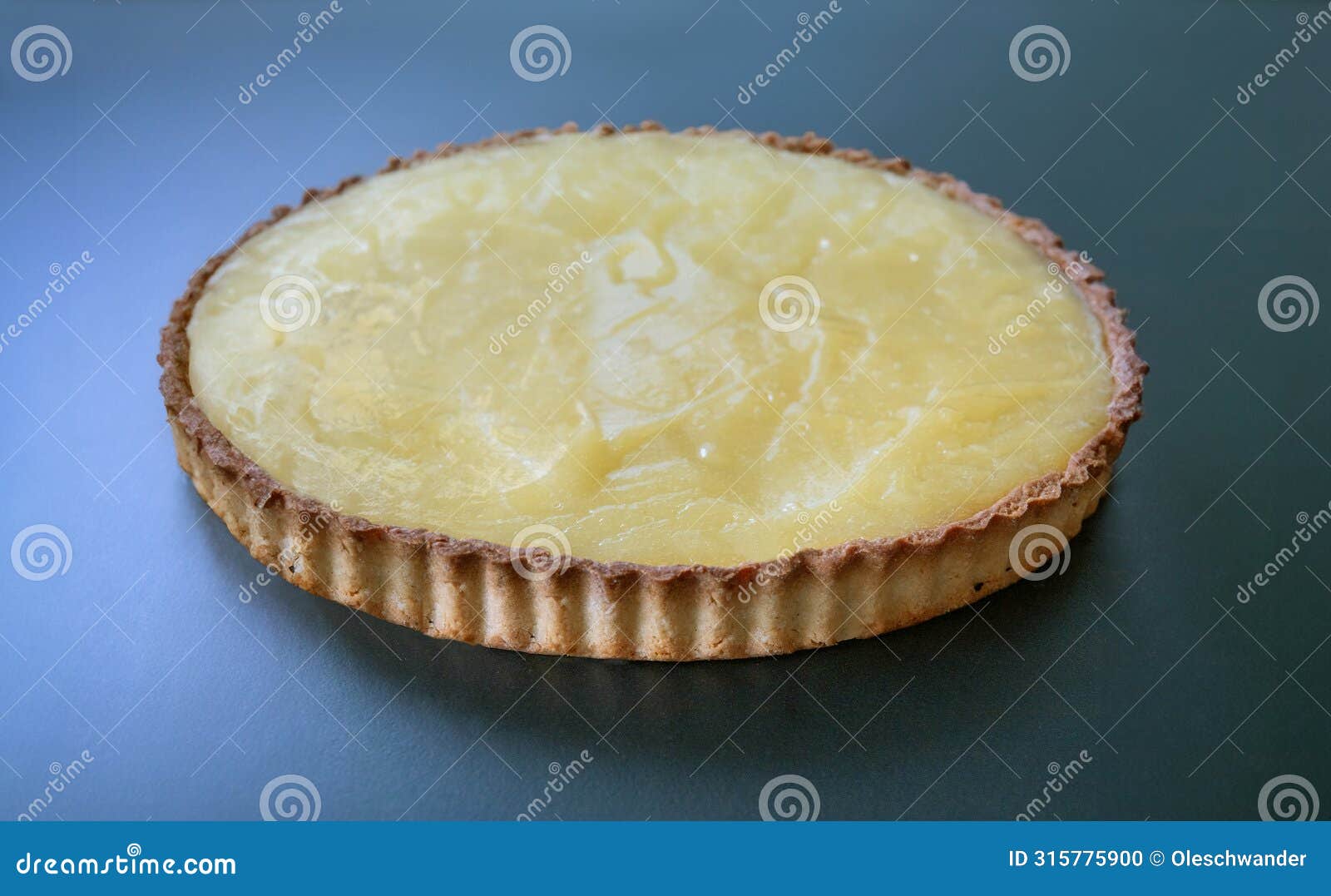 homemade shortcrust pastry lemon pie on turquoise background.