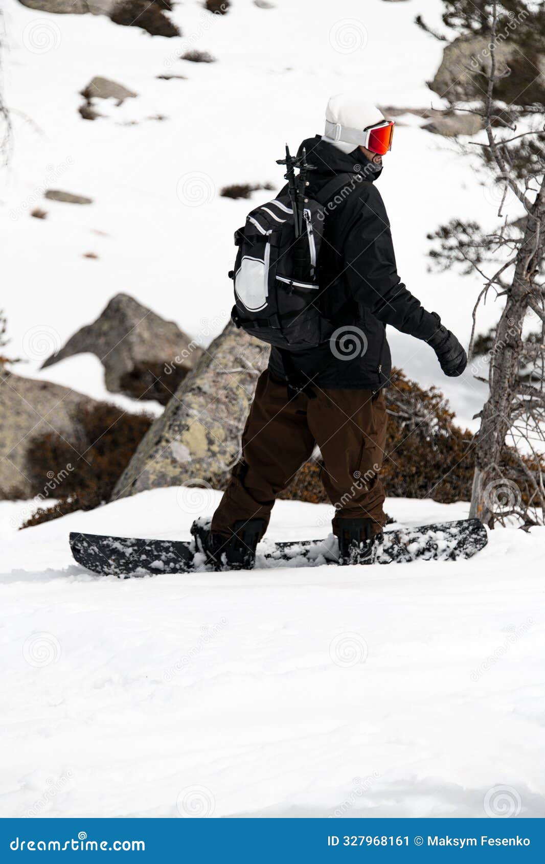 young skier standing with his back to the camera on his splitboard