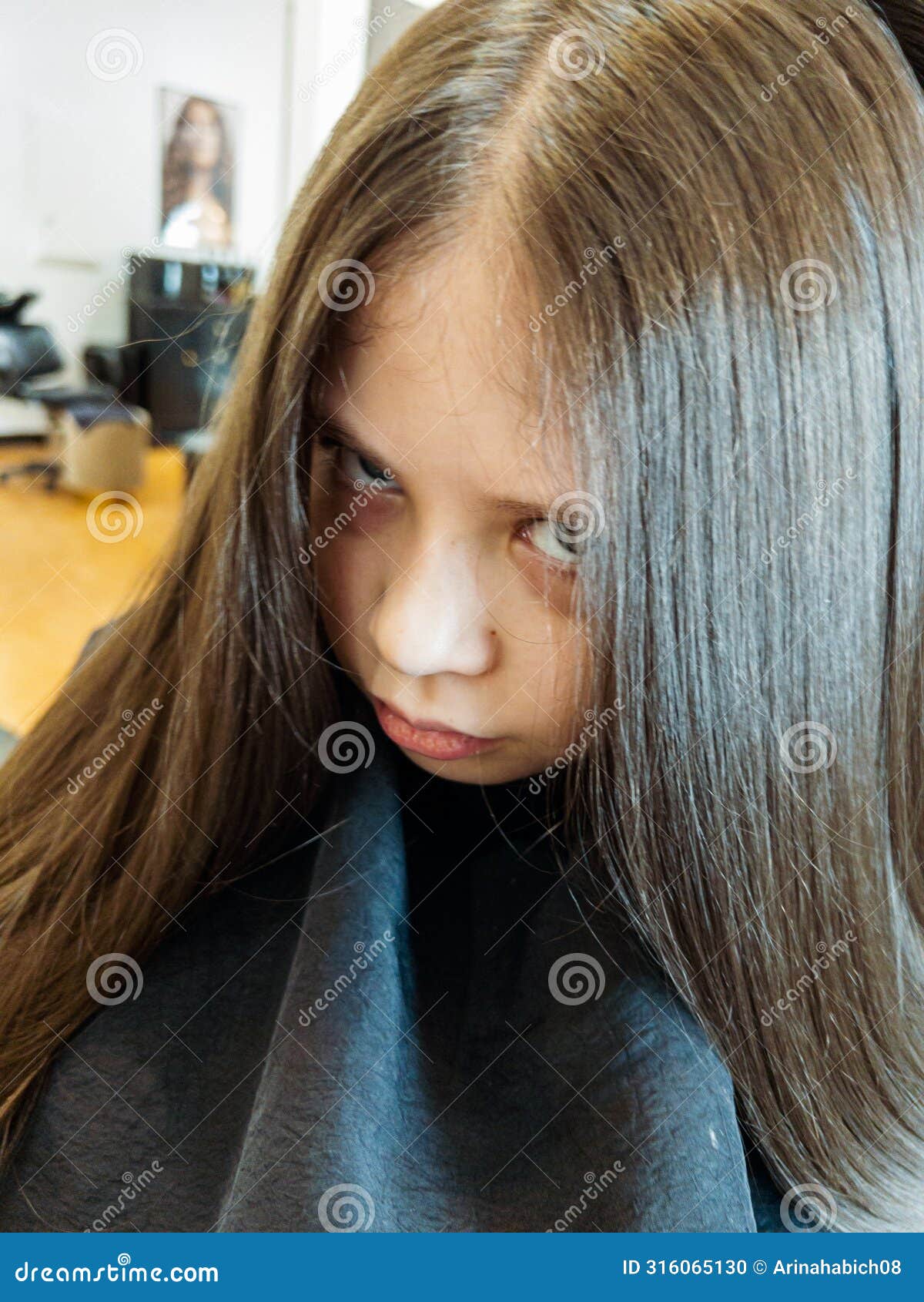 final touches with a hair dryer on a little girl's fresh cut