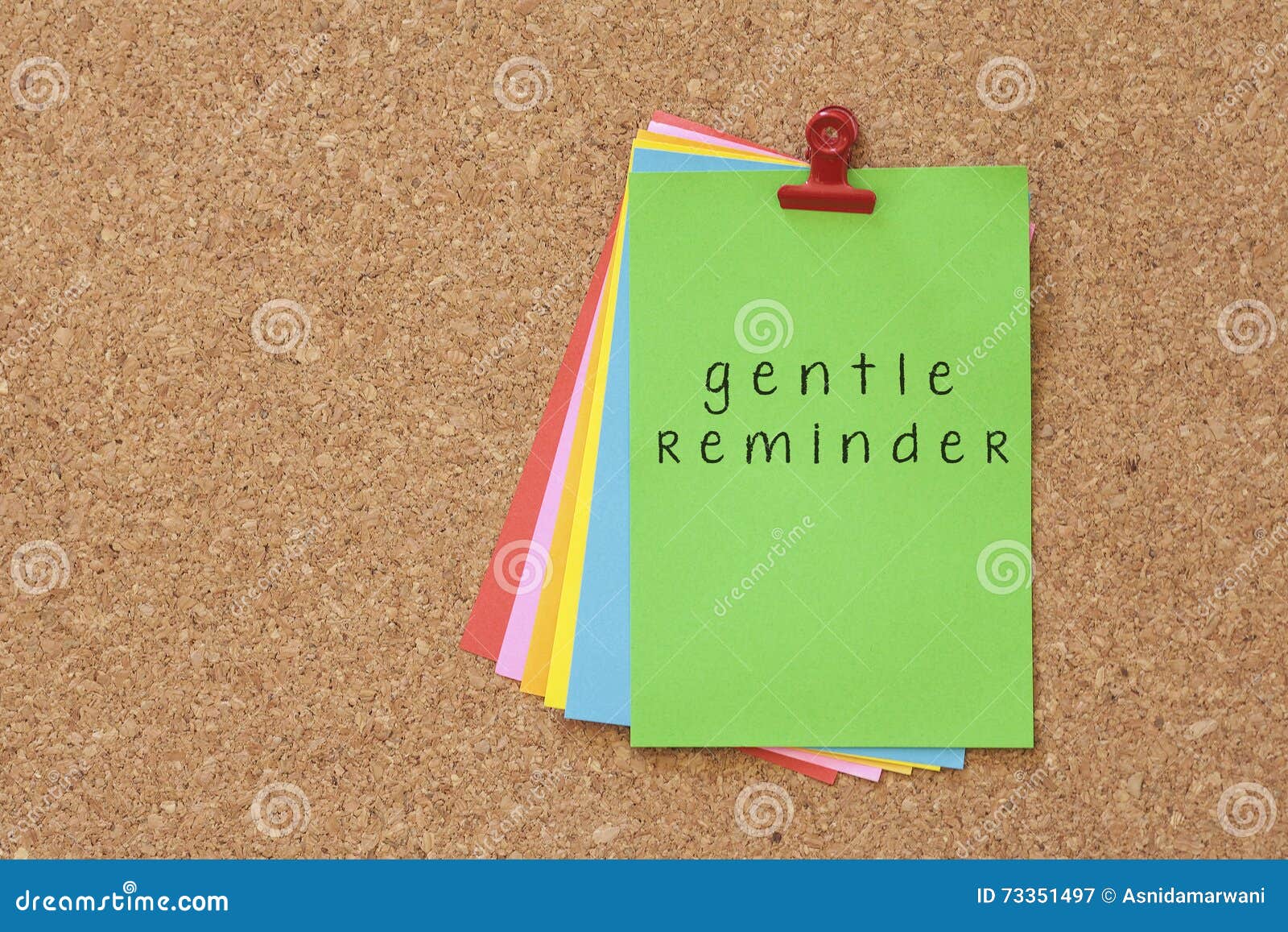 gentle reminder written on color sticker notes over cork board b