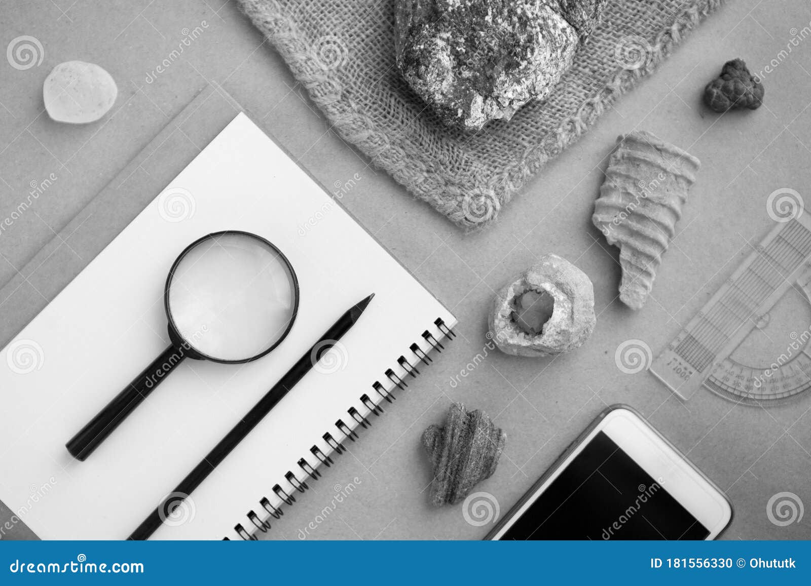 geology rock laboratory. stone samples, loop, notebook and mobile phome at geological laboratory. laboratory for analysis of
