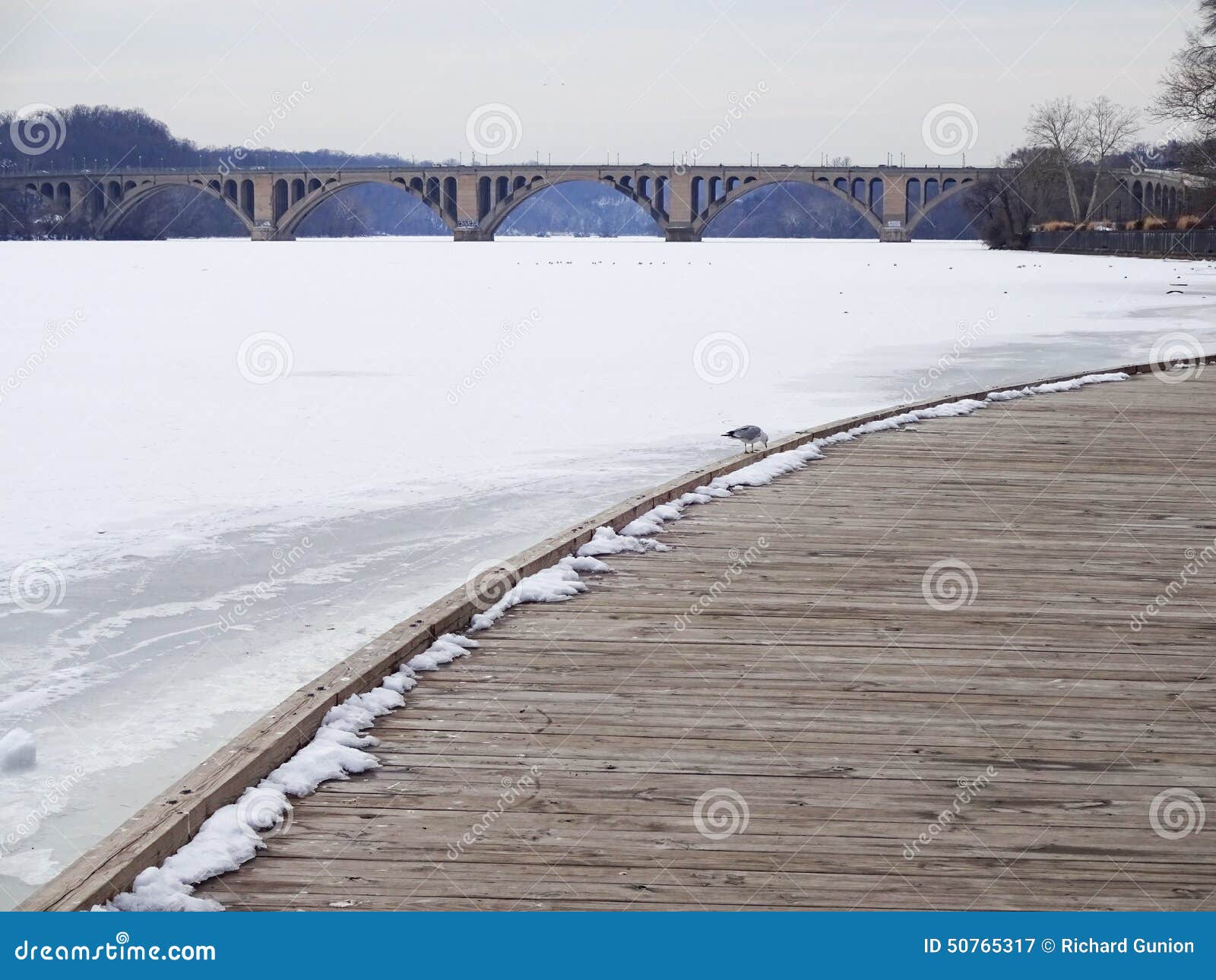 Photo of the the georgetown waterfront and key bridge in washington dc during february. Key bridge connects washington dc and rosslyn virginia.