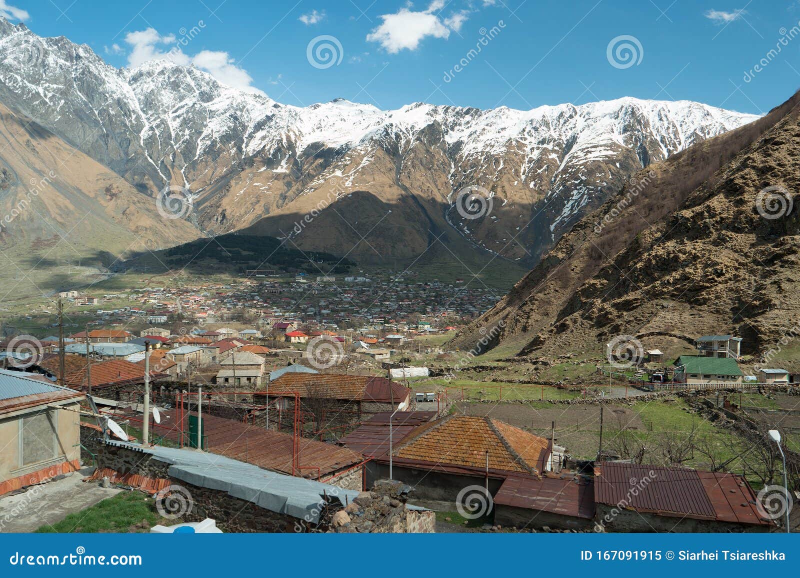 Gergeti and Stepantsminda Villages on the Background of Mountains Stock