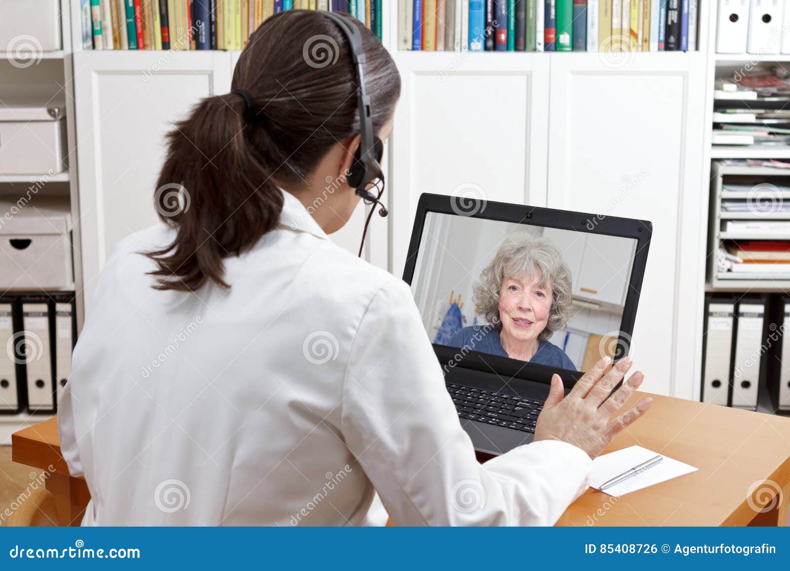 geriatric doctor headset laptop patient