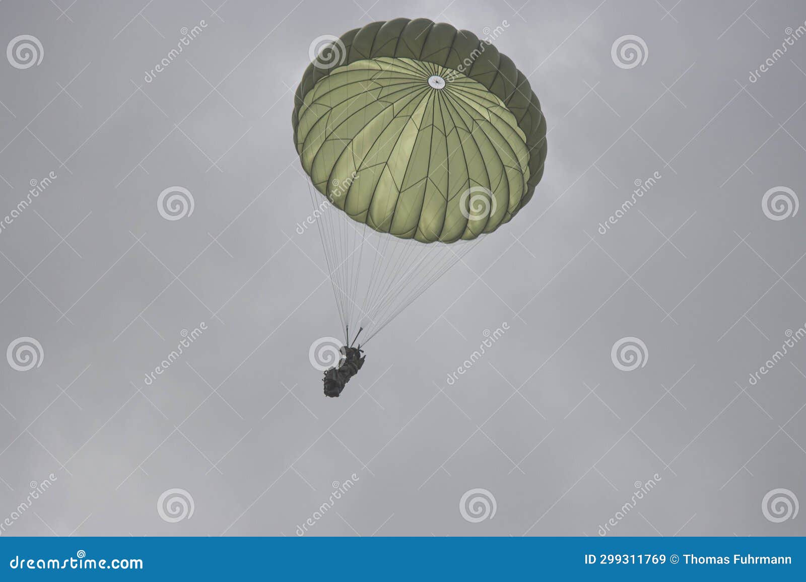 german bundeswehr paratroopers in camouflage during a parachute jump