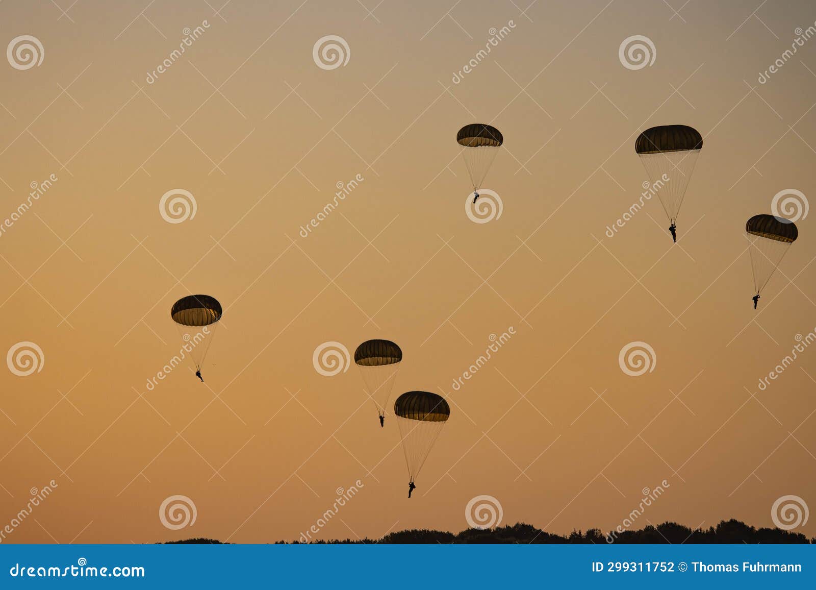german bundeswehr paratroopers in camouflage during a parachute jump
