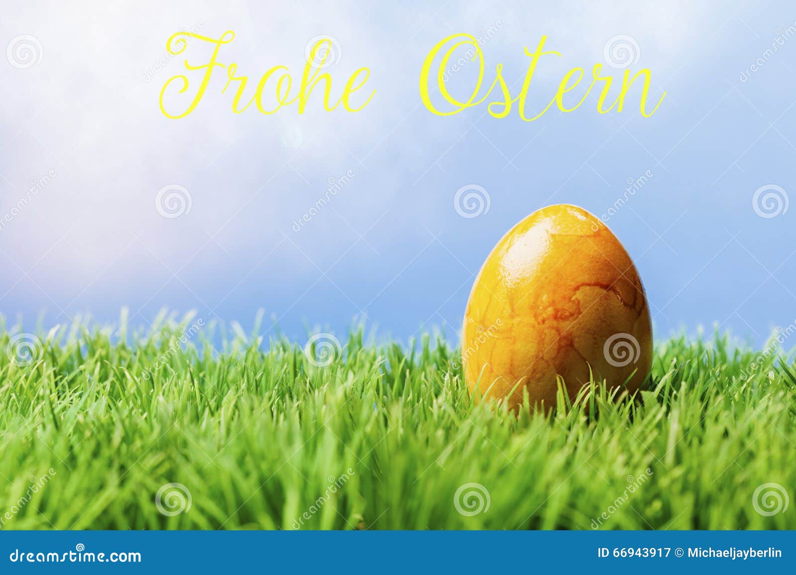 German Easter Greeting Text; Yellow Easter Egg in Grass Stock Image