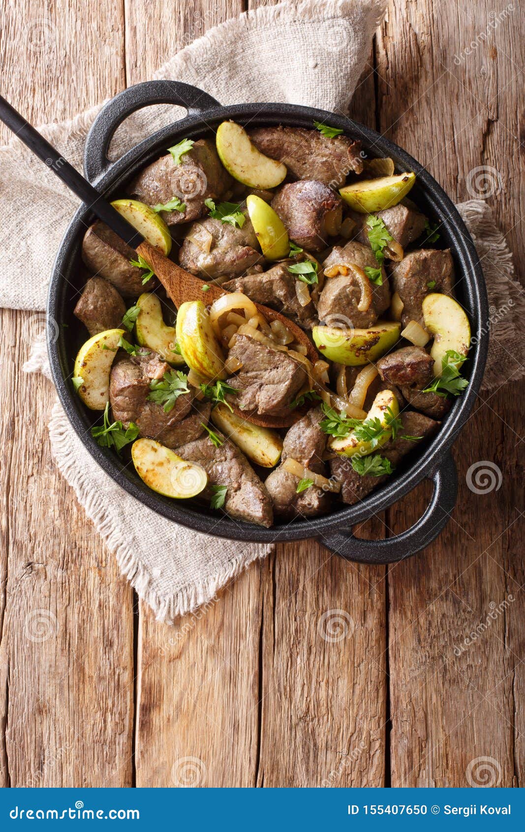 German Food Fried Beef Liver with Green Apples and Onions Close-up in a ...