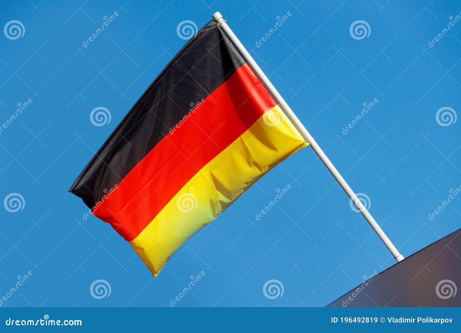 Germany Flag on a Pole Against a Blue Sky Stock Image Image of