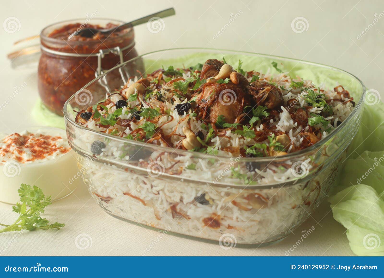 ghee rice and chicken roast. a rice dish made of basmati rice, ghee, spices and garnished with fried onions, cashews and raisins.