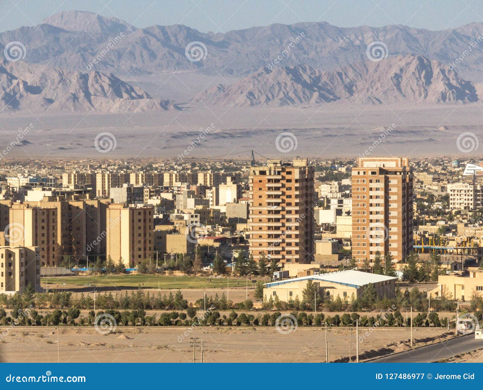 giant construction site in the suburbs of yazd, iran, in the middle of the desert, with dozens of houses being built