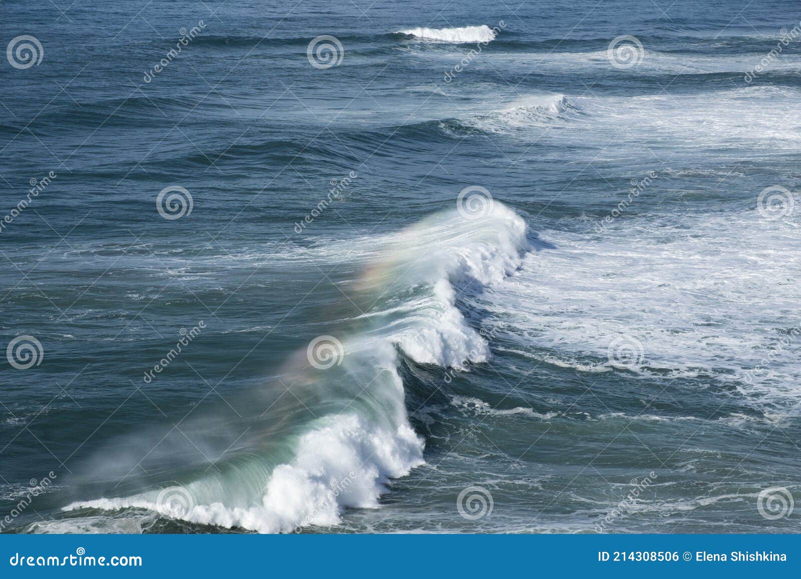 Giant Ocean Waves Crash on the Water Surface Forming a Rainbow Stock 