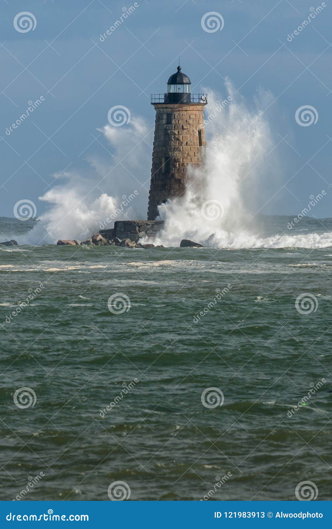 giant waves surround stone lighthouse in maine