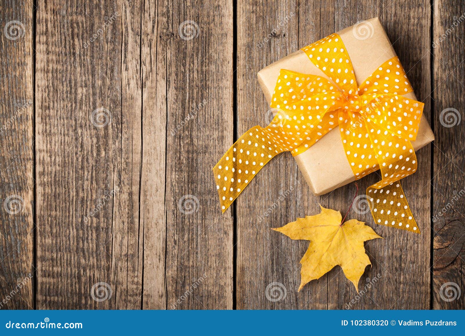 Gift Box and Autumn Maple Leaf on Wooden Background Stock Photo - Image