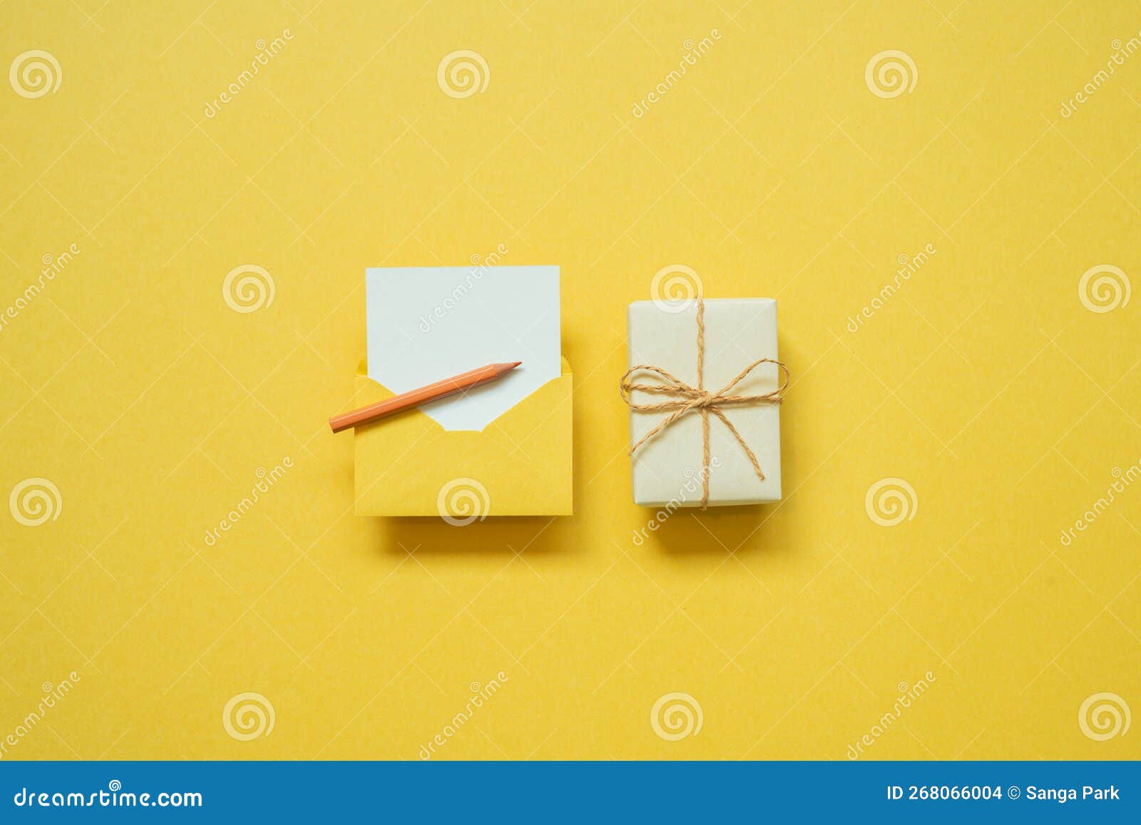 Gift Box and Envelope with White Blank Card on Yellow Background. Top