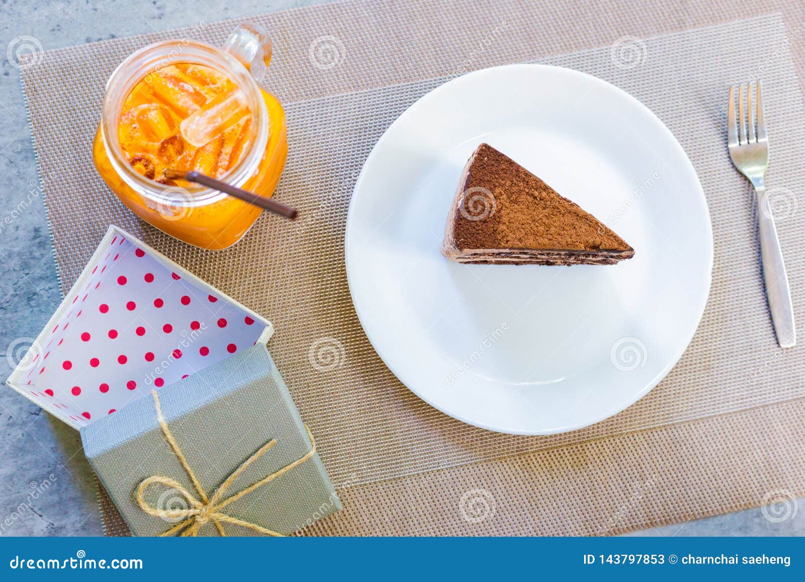 Gift Box Near Cake On Dish And Milk Tea.they Are On Table ... Gift Box Near Cake On Dish And Milk Tea.they Are On Table ...