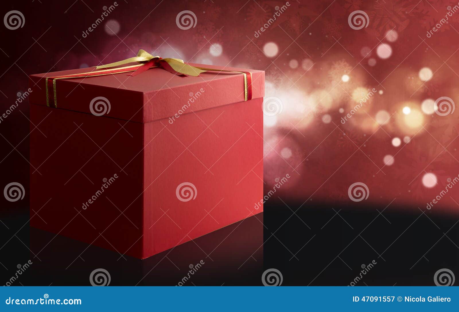gift box over a red and black christmas background.