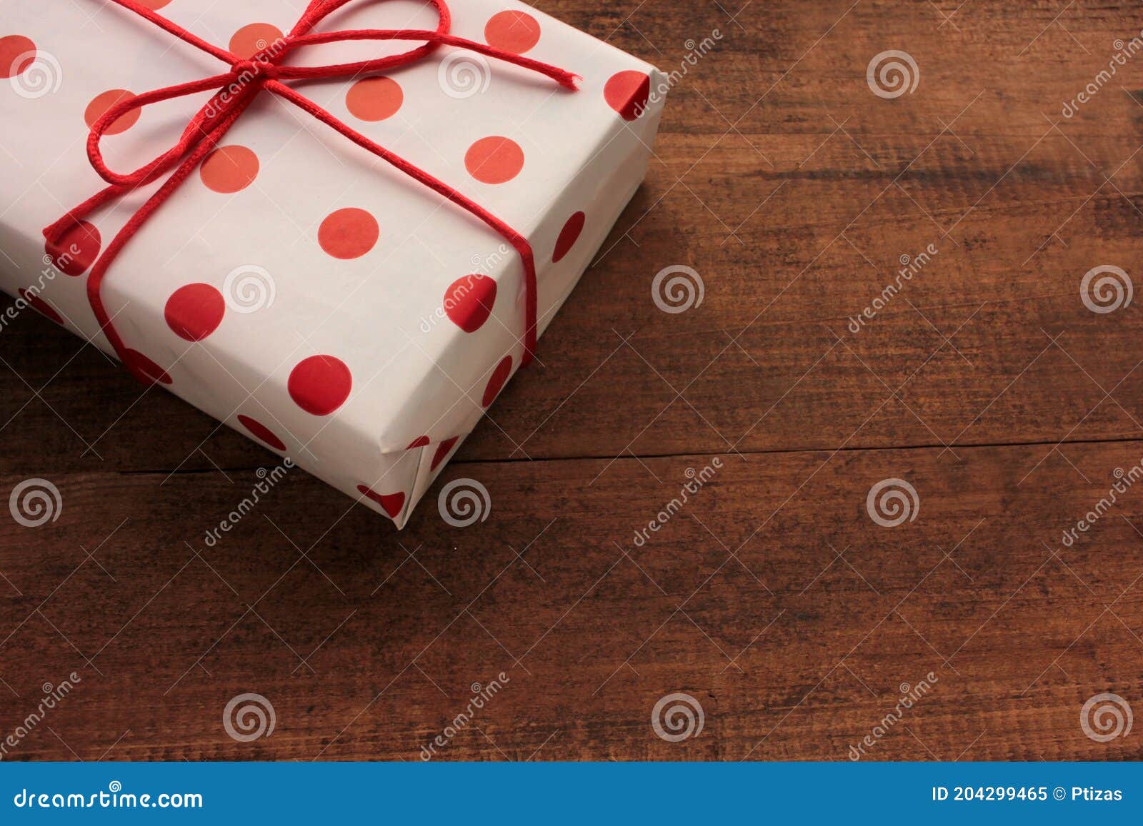 gift box with red ribbon on wooden background. top view