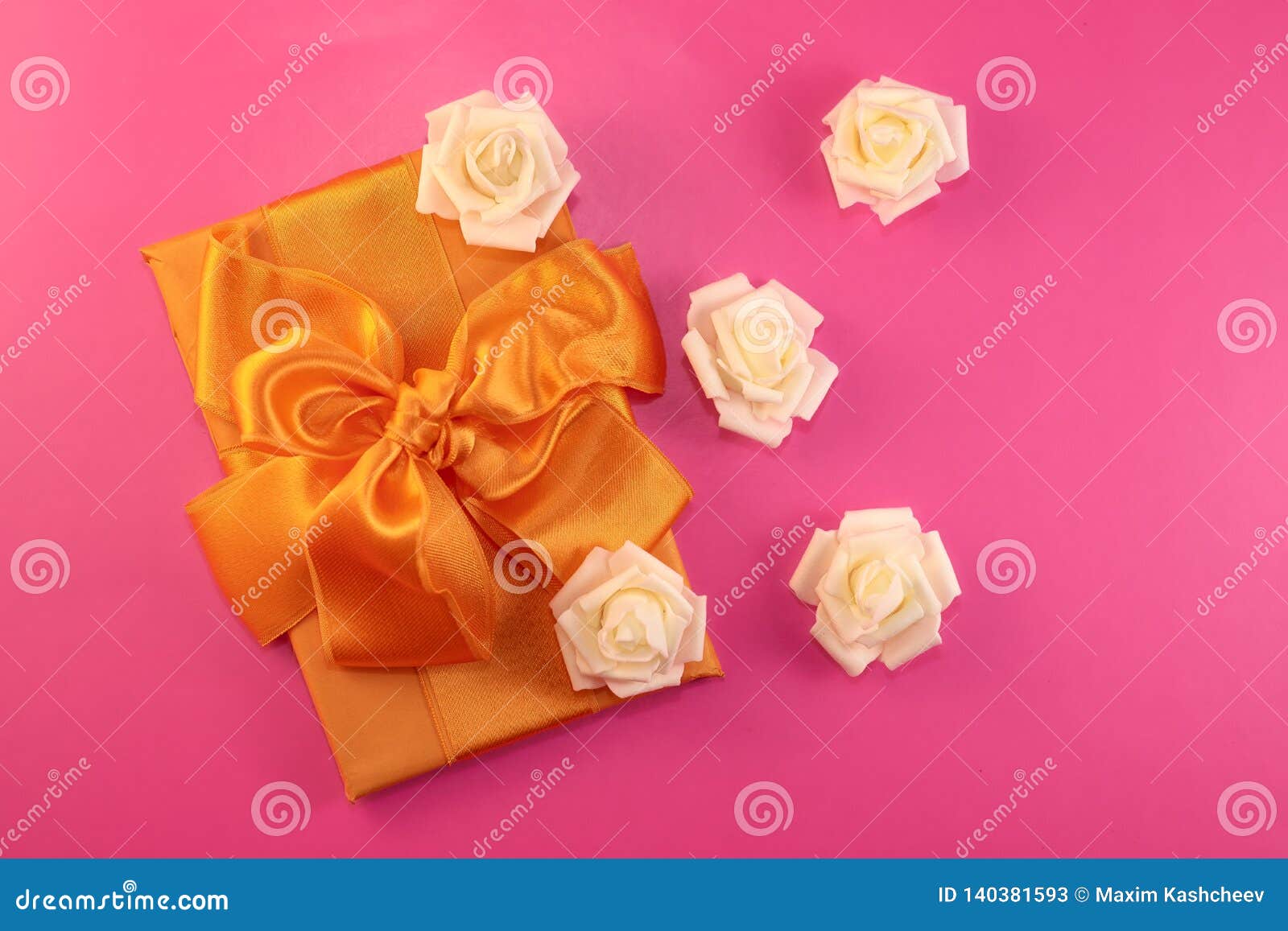 Gift Box with Rose Flowers on Pink Background. Flat Lay Stock Image