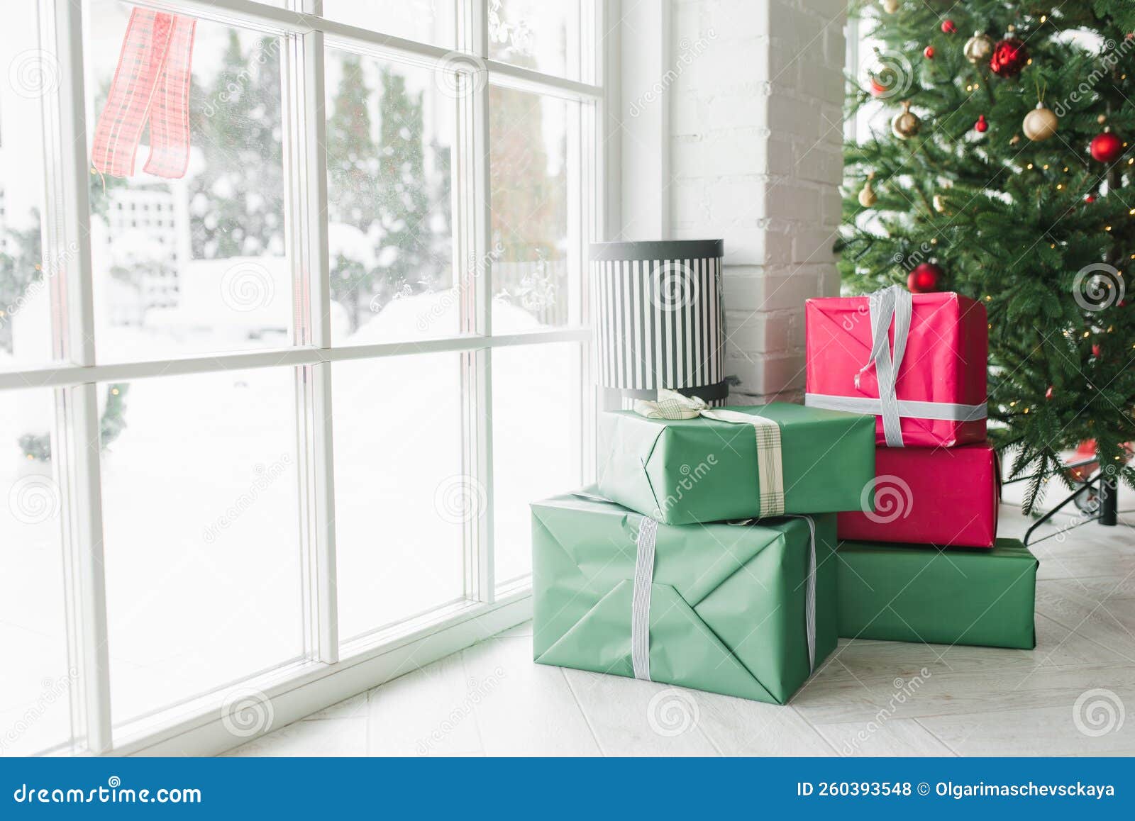 Gift Boxes Under the Christmas Tree Near the Window in a Cozy House