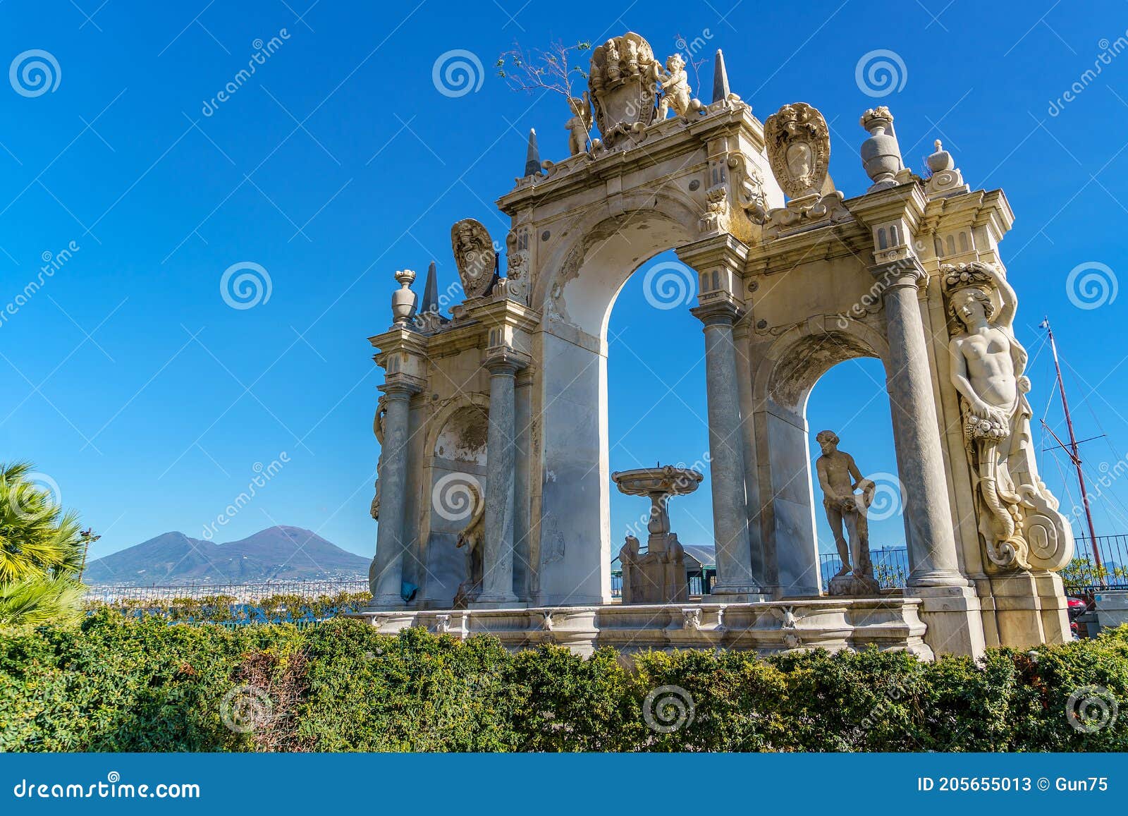 the gigante fountain on the seafront of naples campania italy, the vesuvius volcano on background