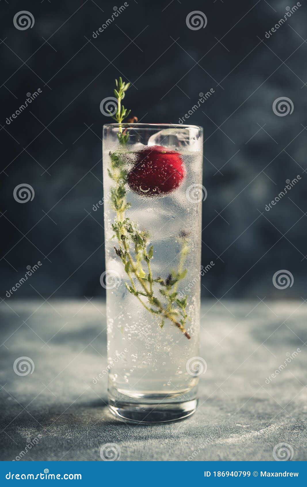 Gin Based Cocktail with Cherries and Thyme Herbs on the Rustic