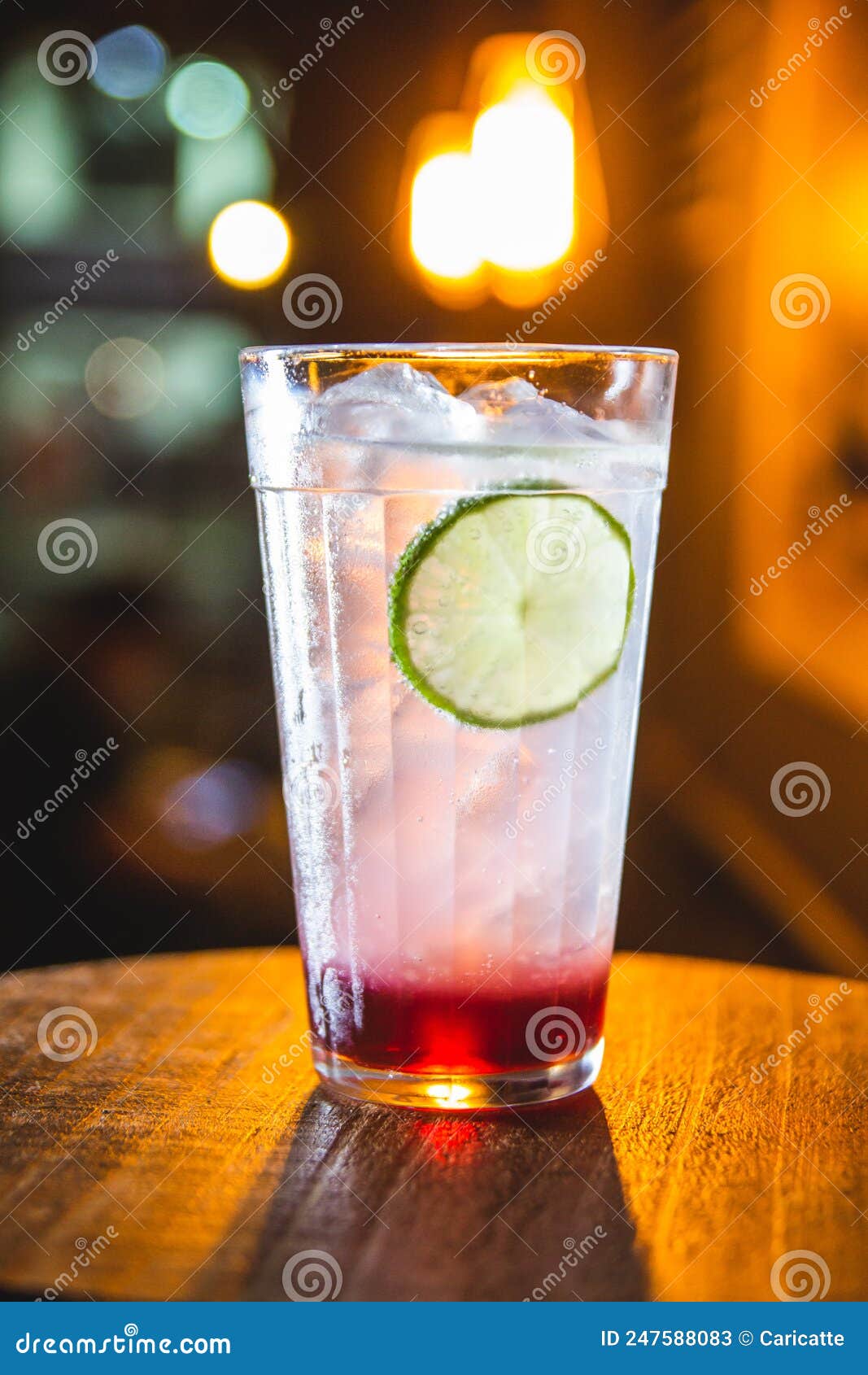 gin tonic with strawberry syrup and lemon slice