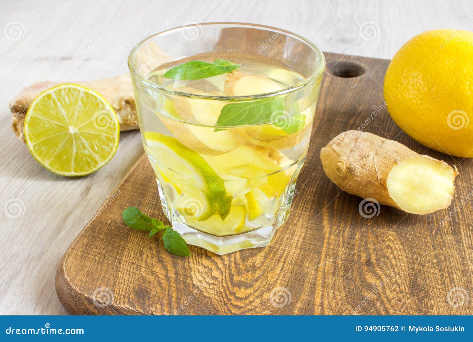 Ginger Ale Soda with Lemon, Mint, Ginger and Ice Over Rustic Wooden