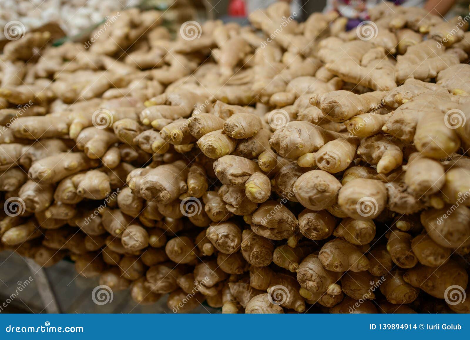 Ginger roots at a market stock photo. Image of food 139894914