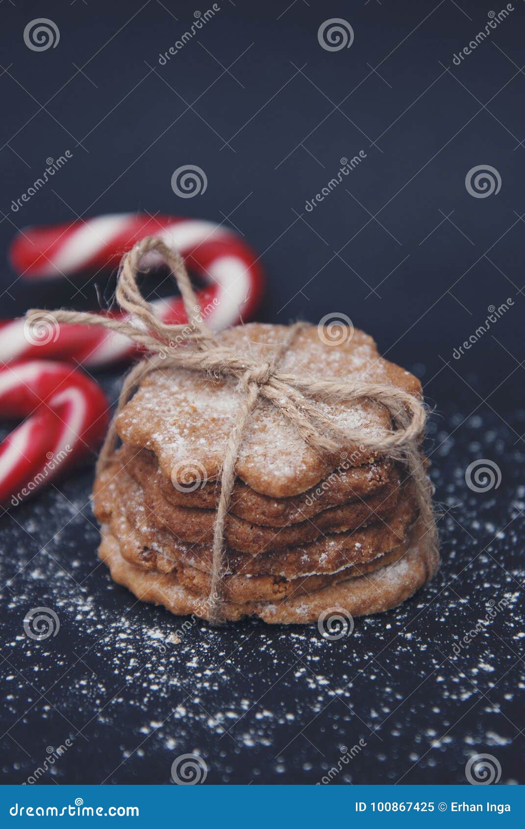 Gingerbread Cookie with Candy Cane on Dark Blue Background with Sugar