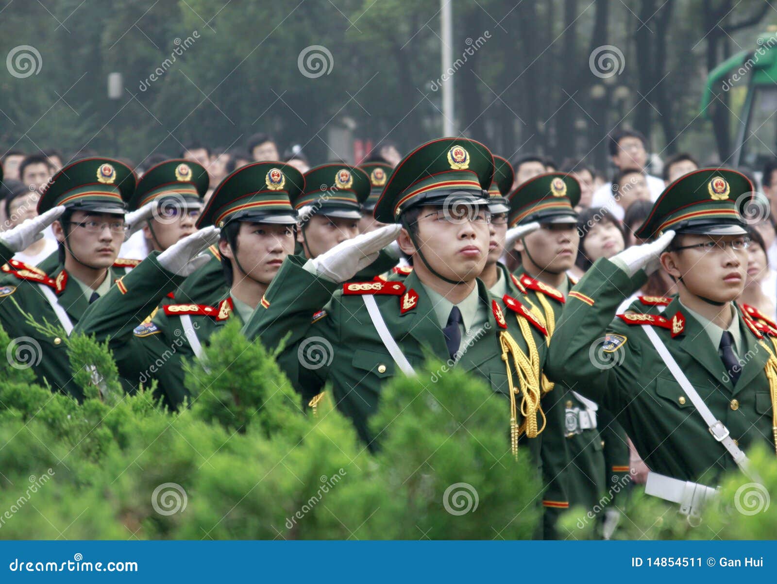 Il giorno di graduazione gli studenti di college hanno salutato alla bandiera nazionale. Tutti weared il vestito di PLA. Posto: Istituto universitario medico di Tongji nella città di Wuhan di China.Time: 2010/6/20